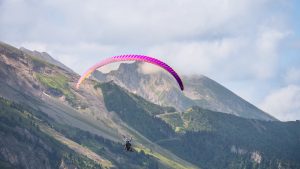 Experience thrilling paragliding over stunning mountain landscapes, perfect for adventure seekers.