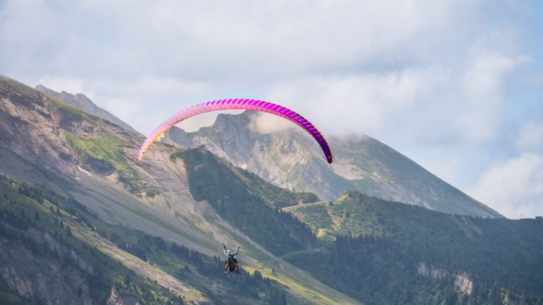 Experience thrilling paragliding over stunning mountain landscapes, perfect for adventure seekers.